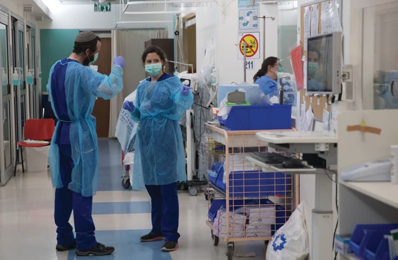A MEDICAL TEAM is seen working at the new biological emergency unit dedicated to COVID-19 at Shaare Zedek Medical Center, in Jerusalem, last year. (photo credit: NATI SHOHAT/FLASH90)