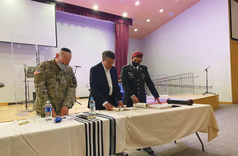 AMBASSADOR AKIVA TOR, with two US Army officers, reading the megillah. (photo credit: Courtesy)