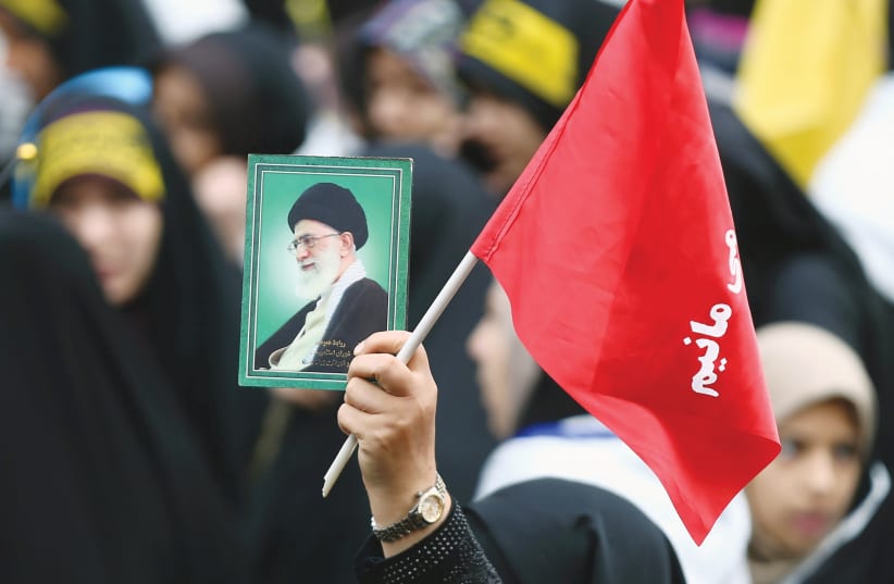 A WOMAN holds a picture of Ayatollah Ali Khamenei, at an anti-US demonstration near the old US embassy in Tehran in 2019. (photo credit: NAZANIN TABATABAEE/REUTERS)