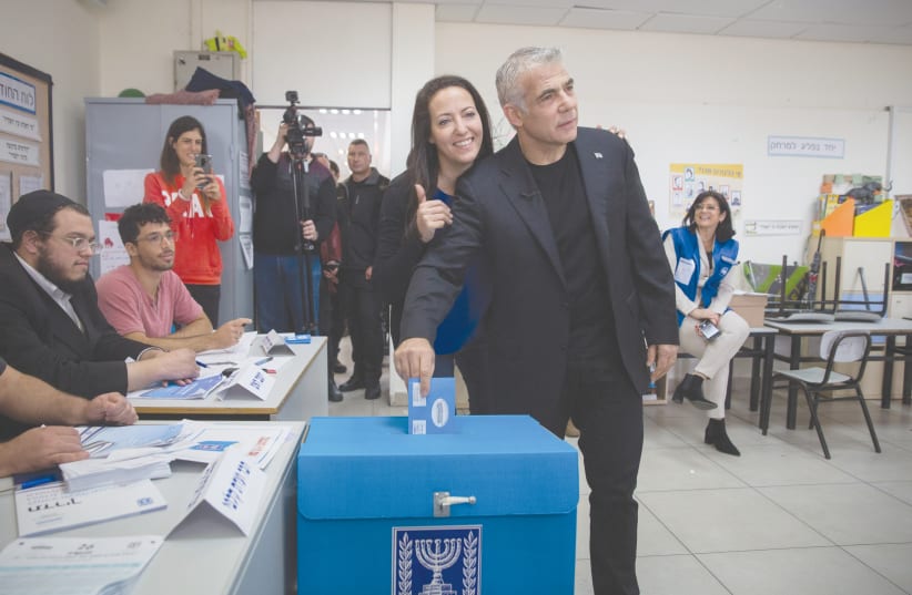 YAIR LAPID casts his ballot at a voting station in Tel Aviv during the Knesset elections on March 2, 2020. (photo credit: MIRIAM ALSTER/FLASH90)