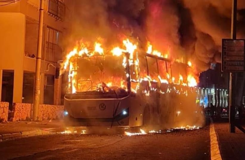 SIMMERING ANGER: The torched bus burns in Bnei Brak in late January. (photo credit: ISRAEL POLICE SPOKESMAN)
