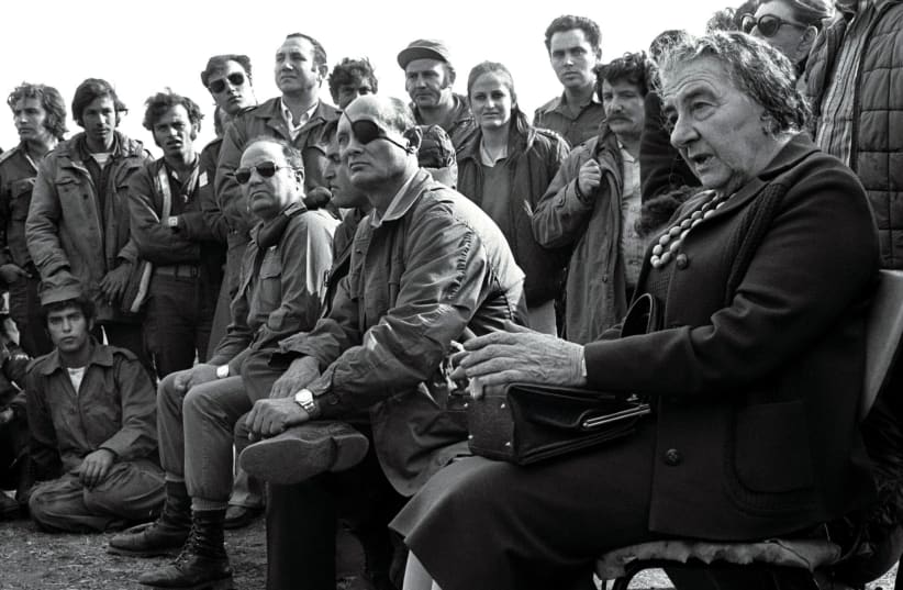 PRIME MINISTER Golda Meir accompanied by Defense Minister Moshe Dayan on the Golan Heights in 1973 after the Yom Kippur War. The author’s account is set against Israel’s own story of triumphs and disasters connected to the war. (photo credit: REUTERS)