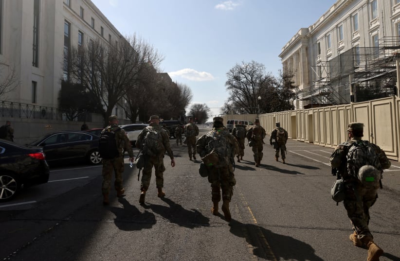 National Guard soldiers patrol the compound around the US Capitol after police warned that a militia group might try to attack the Capitol complex in Washington, US, March 4, 2021. (photo credit: REUTERS/JONATHAN ERNST)