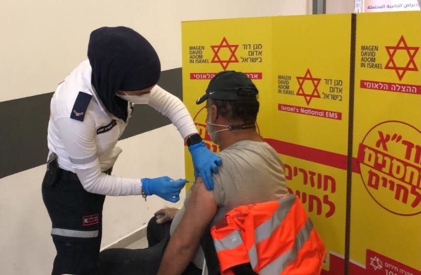 Palestinian workers getting vaccinated against the coronavirus, March 4, 2021.  (photo credit: COGAT)