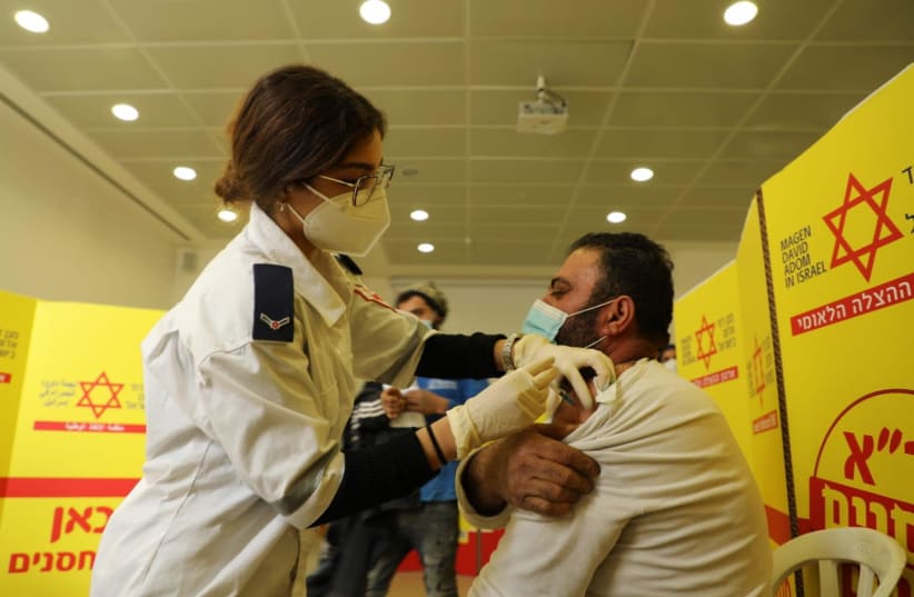 Palestinian workers getting vaccinated against the coronavirus, March 4, 2021.  (photo credit: COGAT)