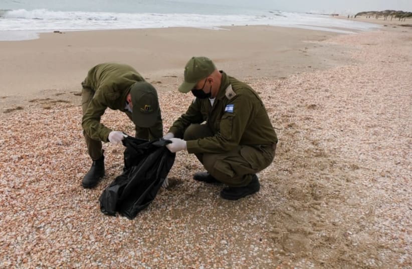Soldiers from Special in Uniform clean up Israel's beaches, following an oil spill that has brought tar to Israel's shore. (photo credit: SPECIAL IN UNIFORM)
