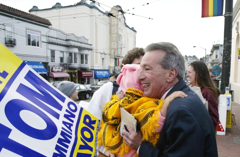 San Francisco Supervisor and mayoral candidate Tom Ammiano hugs supporters before voting in the Castro District of San Francisco on Election Day, November 4, 2003. (photo credit: REUTERS/SUSAN RAGAN SR/GAC)