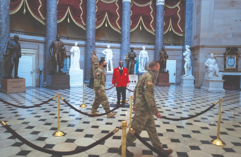US NATIONAL GUARD soldiers walk through Statuary Hall on Capitol Hill in Washington three weeks after the Capitol riot. Real leaders care about the hearts they hold as they walk people through the inevitable human experience of loss. (photo credit: TOM BRENNER/REUTERS)