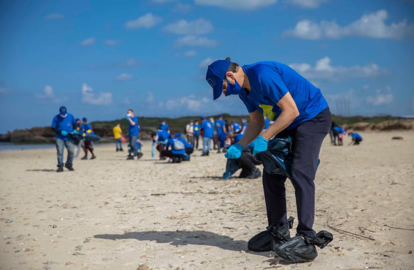 EU Ambassador to Israel Emanuele Giaufret was joined by more than two dozen envoys from EU member states, including 10 ambassadors, at a large-scale beach clean-up operation at the Beit Yanai National Park near Netanya, Friday, March 5, 2021. (photo credit: ELI DASSA)