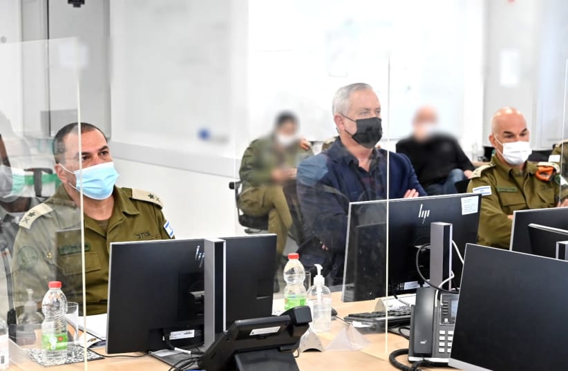Defense Minister Benny Gantz listening to an IDF briefing on Tuesday March 9 2021 (photo credit: ARIEL HERMONI / DEFENSE MINISTRY)