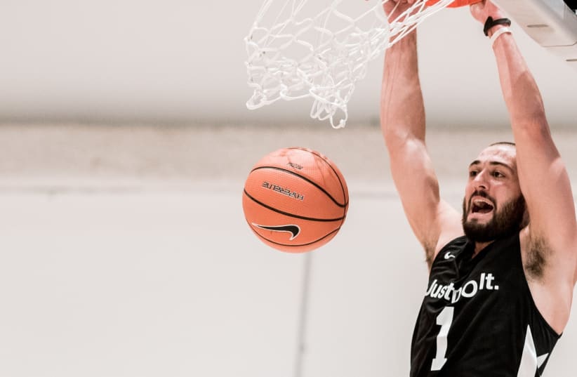MIKE KAUFMAN definitely get around all over the basketball map  seen dunking at a Nike tournament in New York (photo credit: Courtesy)