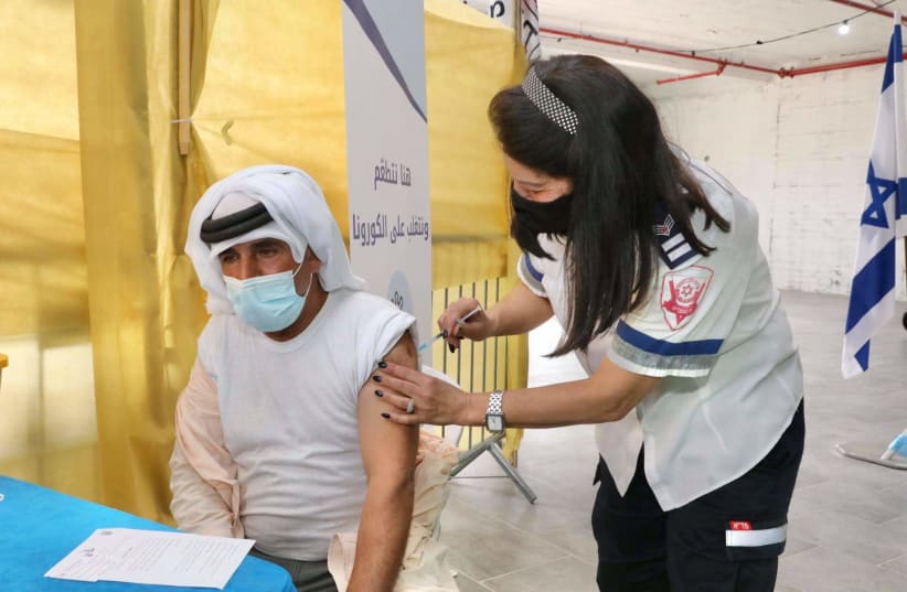 Palestinians receive the vaccine in a joint operation run by the Office of the Coordinator of the Government Activities in the Territories (COGAT), the Health Ministry and Magen David Adom that began on March 2nd 2021. (photo credit: MARC ISRAEL SELLEM)