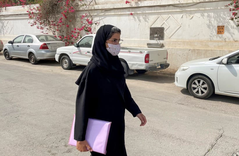 Saudi activist Loujain Al-Hathloul makes her way to appear at a special criminal court for an appeals hearing in Riyadh (photo credit: REUTERS)
