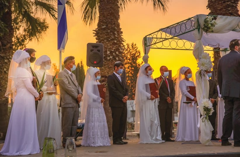 FIVE PAIRS of Bnei Menashe immigrants remarry in a traditional Jewish wedding ceremony last week.  (Laura Ben-David/Shavei Israel) (photo credit: LAURA BEN-DAVID/SHAVEI ISRAEL)