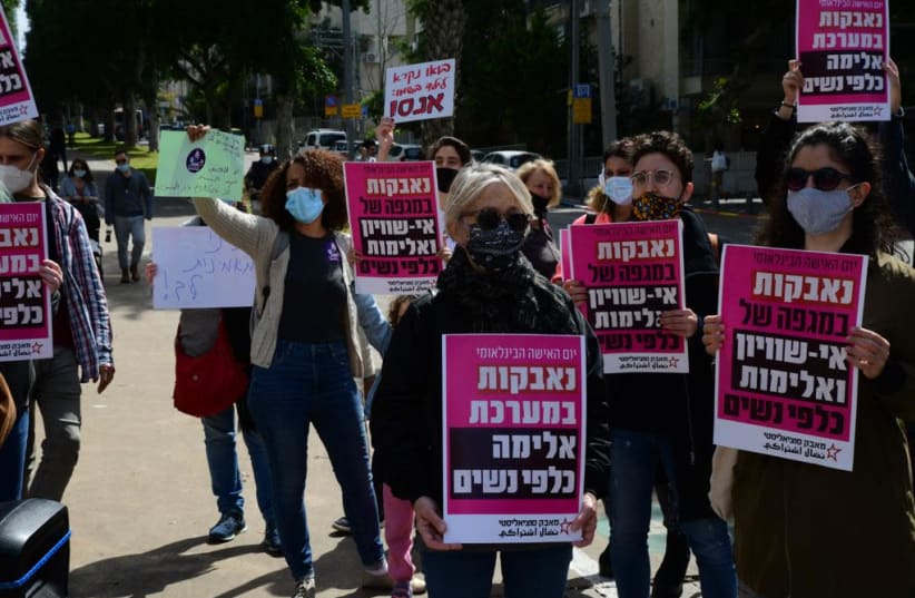 Protesters hold signs opposing a "system of violence against women" (photo credit: AVSHALOM SASSONI)
