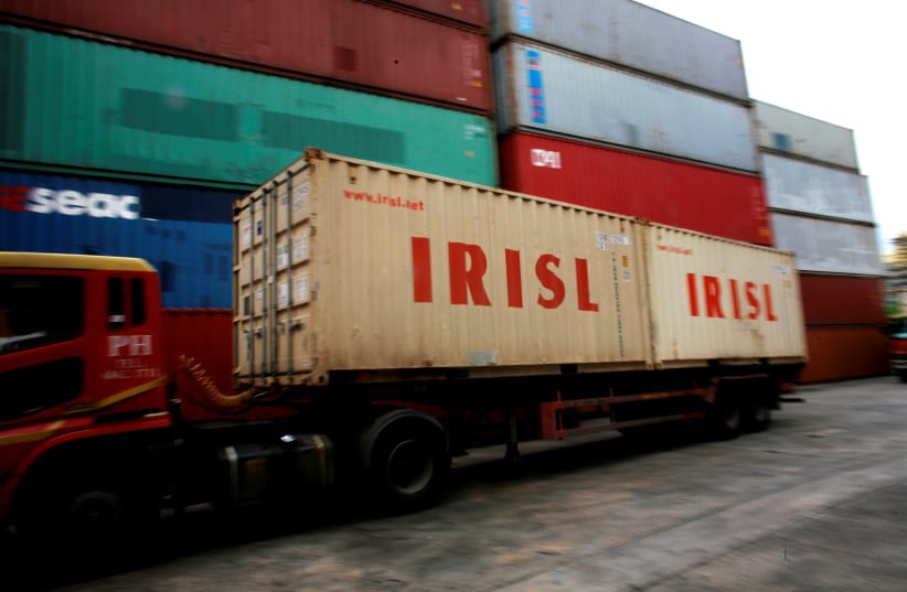A truck carrying Islamic Republic of Iran Shipping Lines (IRISL) containers arrives a depot in northern Singapore (photo credit: THOMAS WHITE / REUTERS)