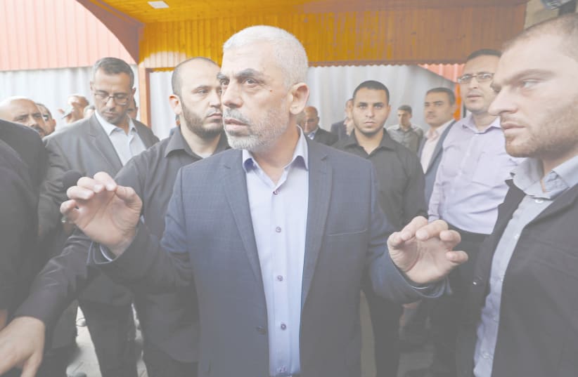 GAZA’S HAMAS CHIEF Yahya Sinwar talks to the media before meeting with Palestinian Central Election Committee Chairman Hana Naser, in Gaza City in 2019. (photo credit: MOHAMMED SALEM/ REUTERS)