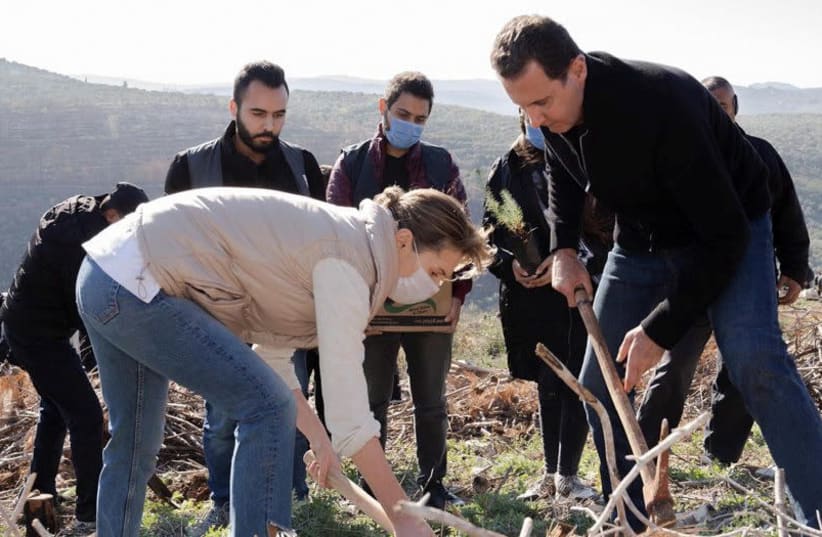 Syria's President Bashar Assad and his wife Asma, plant trees in city of Draykish, near Tartous, Syria December 30, 2020. (photo credit: SANA/HANDOUT VIA REUTERS)