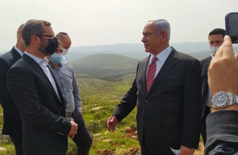 Prime Minister Benjamin Netanyahu during a visit to the Givat Harel outpost in Binyamin region of the West Bank, March 14, 2021 (photo credit: YEHOSHUA MENASHE)