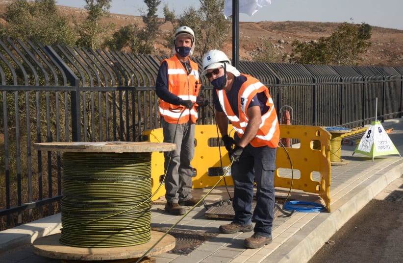 Bezeq workers lay fiber optics lines in Metulla. (photo credit: Courtesy)