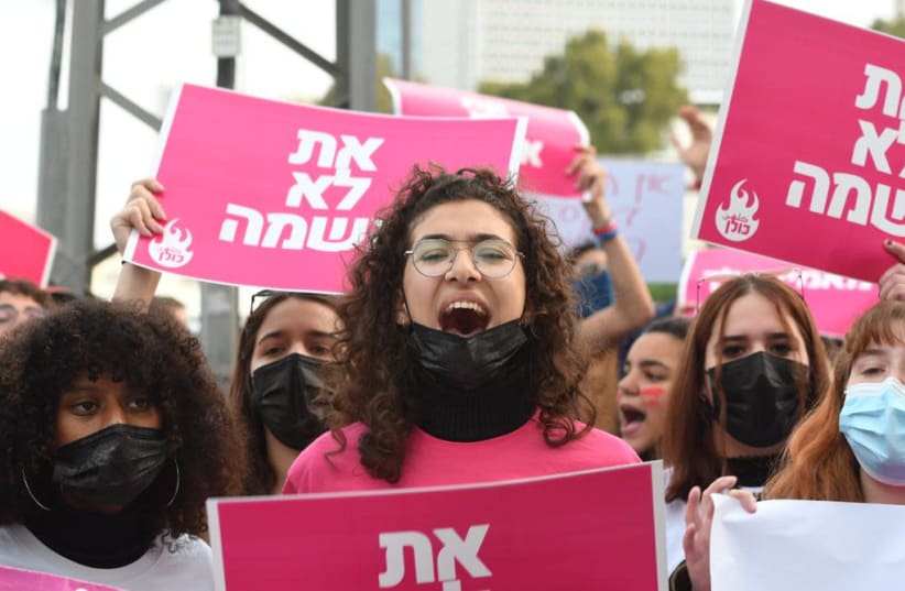 "You are not guilty," read signs at the protest against the recent violence against women, March 15, 2021.  (photo credit: AVSHALOM SASSONI/ MAARIV)