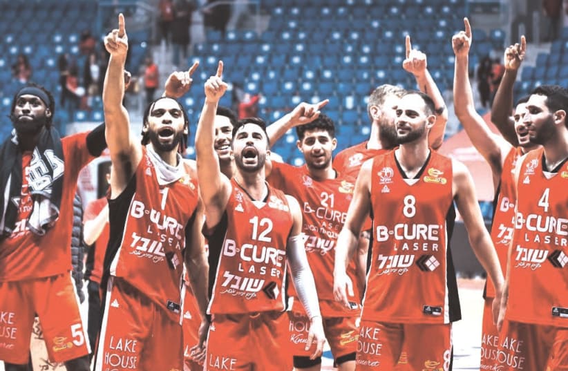  HAPOEL HAIFA players celebrate on the court after their surprise 100-87 road victory over Hapoel Jerusalem in Israel Winner League action in the capital. (photo credit: DOV HALICKMAN PHOTOGRAPHY)