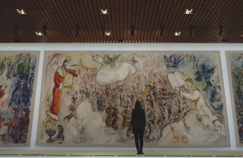 As part of Beit Avi Chai's online offerings, Israeli journalist Romy Neumark, center, narrates a series of short films on artistic works that bring Jewish holidays to light, including this painting by Marc Chagall at Israel's Knesset. (photo credit: BEIT AVI CHAI)