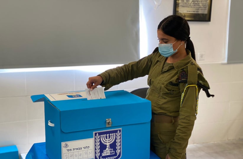 IDF soldier voting early for the 2021 elections (photo credit: IDF SPOKESPERSON'S UNIT)