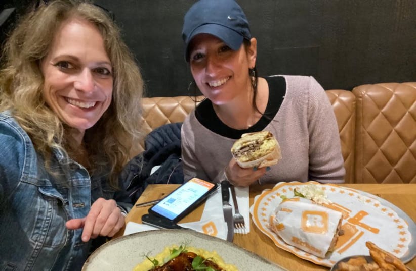 THE AUTHOR (right) and her friend Laura Ben-David celebrate by eating in a restaurant. (photo credit: LAURA BEN-DAVID)