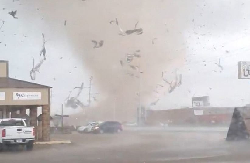 A screen grab from a social media video shows a tornado wrecking havoc in Jonesboro, Arkansas, U.S. March 28, 2020. (photo credit: REUTERS)