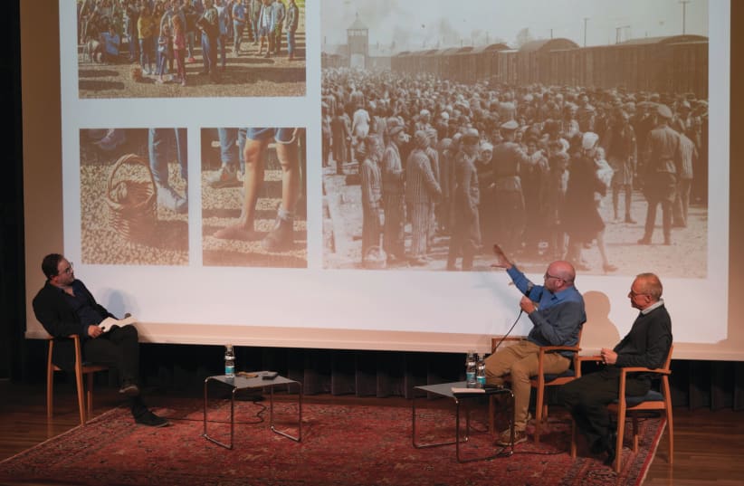 MATAN BEN CNAAN (center) points out similarities in his painting to a Holocaust photograph, as curator Amitai Mendelsohn (left) and David Grossman look on. (photo credit: OFRIT ROSENBERG, ISRAEL MUSEUM)