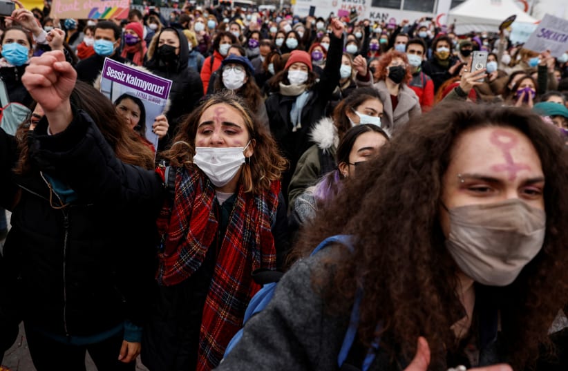 Activists participate in a protest against Turkey's withdrawal from Istanbul Convention, an international accord designed to protect women, in Istanbul, Turkey March 20, 2021. (photo credit: UMIT BEKTAS / REUTERS)