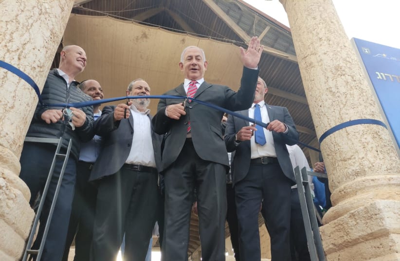 Prime Minister Benjamin Netanyahu cutting a ribbon at the site of the ancient Sussiya synagogue in the South Hebron Hills last week. (photo credit: DUDI AVITAN)