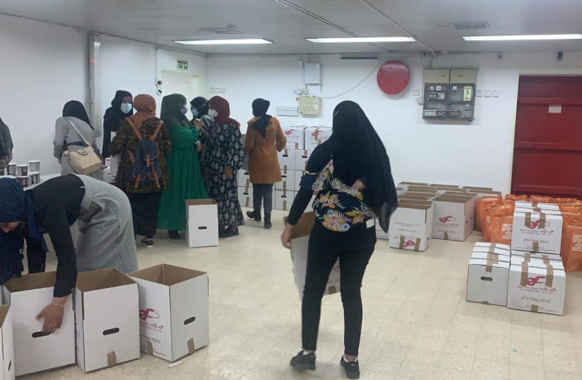 Bedouin activists pack food-aid boxes meant for Jewish families ahead of Passover  (photo credit: AGUDA SHERUT)