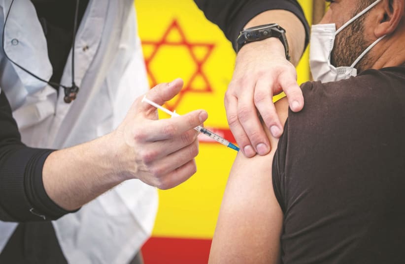 GETTING VACCINATED in Jerusalem. It is still too early to say COVID-19 is behind us and yet it is necessary to give due where it has been rightfully earned. (photo credit: OLIVIER FITOUSSI/FLASH90)