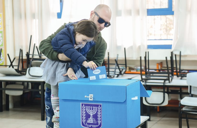 People cast their ballot at a voting station in Tel Aviv during the Knesset election on March 2, 2020. (photo credit: FLASH90)