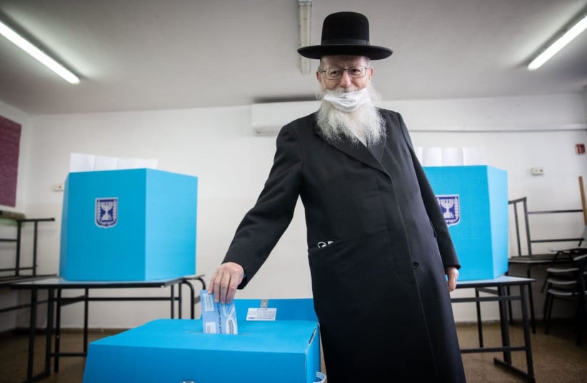 Construction and Housing Minister Ya’acov Litzman votes in Israel's March 23, 2021 election. (photo credit: YONATAN ZINDEL/FLASH 90)