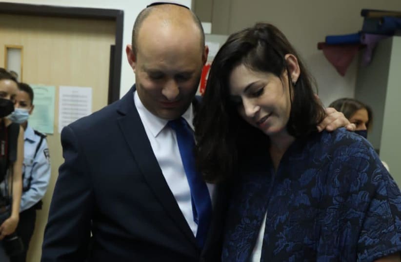 Right-wing chairman and candidate for prime minister, Naftali Bennett, now votes in Raanana accompanied by his wife Gilat (photo credit: ARIEL ZANDBERG)