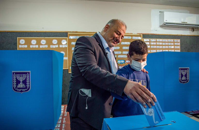 Ra'am Party leader Mansour Abbas casts his vote at a voting station in Maghar, during the Knesset Elections, on March 23, 2021. (photo credit: FLASH90)