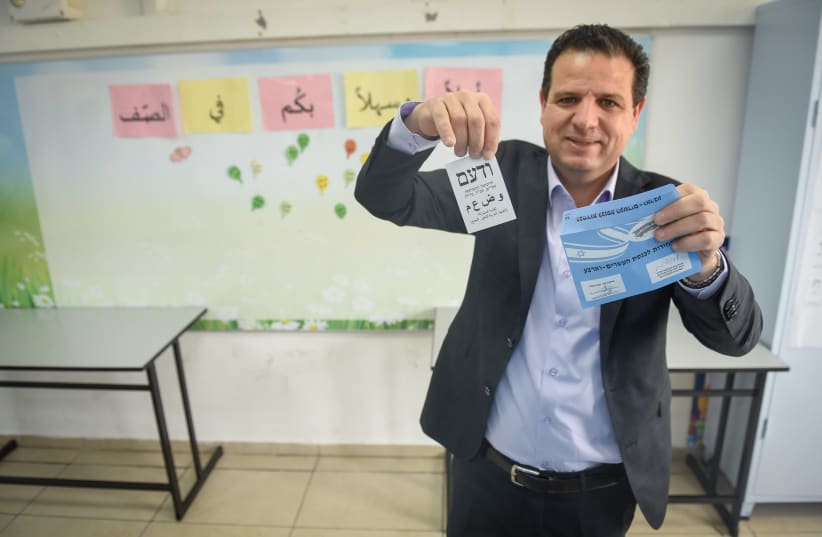 Joint List Party leader Ayman Odeh casts his ballot at a voting station in Hafia, during the Knesset Elections, on March 23, 2021. (photo credit: RONI OFER/FLASH90)