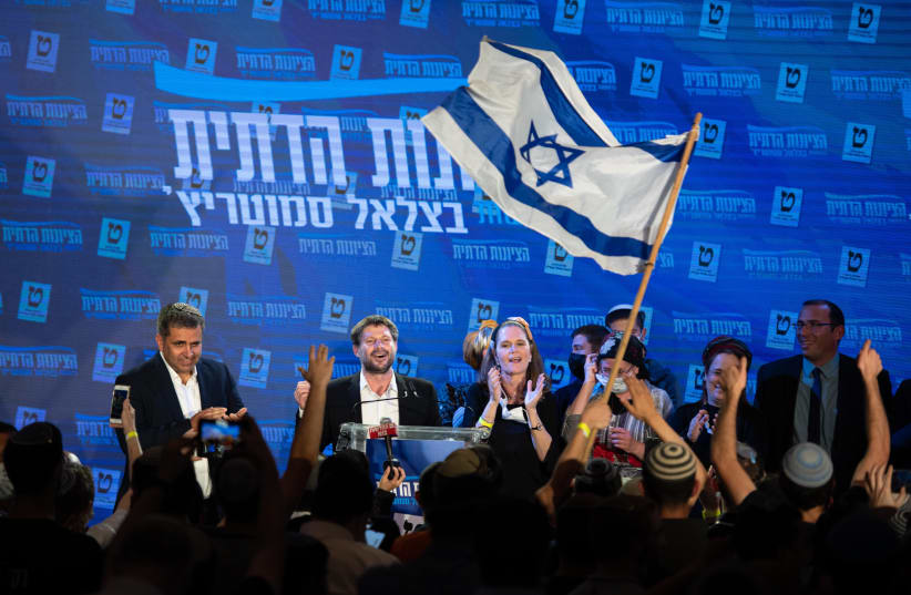 Bezalel Smotrich and party members are seen with supporters at the Religious Zionist Party headquarters in Modi'in, on elections night, March 23, 2021. (photo credit: SRAYA DIAMANT/FLASH90)