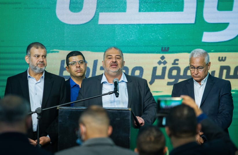 Ra'am Party leader Mansour Abbas and party members at the party headquarters in Tamra, on election night, March 23, 2021. (photo credit: FLASH90)