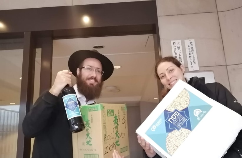 Chabad emissaries in the Far East distributing Passover packages of matzah and wine (photo credit: CHABAD)