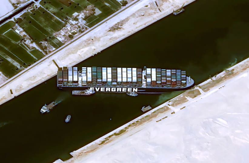 A satellite image shows stranded container ship Ever Given ran around in Suez Canal, Egypt March 25, 2021. (photo credit: CNES/AIRBUS DS VIA REUTERS)