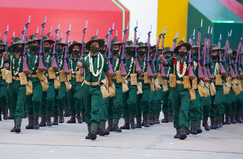 Military personnel participate in a parade on Armed Forces Day in Naypyitaw, Myanmar, March 27, 2021.  (photo credit: REUTERS/STRINGER)