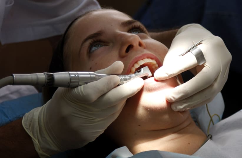 A young lady has dental work done at a local dentist in Jerusalem July 22, 2008.  (photo credit: DANIEL DREIFUSS/FLASH 90)
