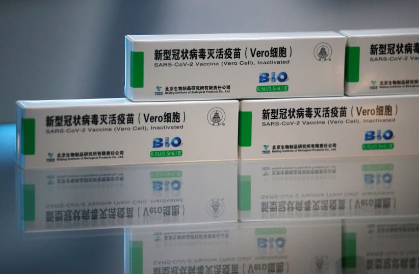 Packages of COVID-19 vaccines by Beijing Institute of Biological Products of Sinopharm's China National Biotec Group (CNBG), are displayed during a government-organised visit to the vaccine’s production line in Beijing, China February 26, 2021.  (photo credit: REUTERS/TINGSHU WANG)