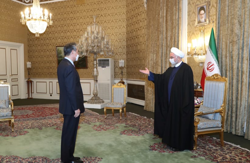 Iranian President Hassan Rouhani meets with Chinese Foreign Minister Wang Yi, in Tehran, Iran March 27, 2021. (photo credit: REUTERS)