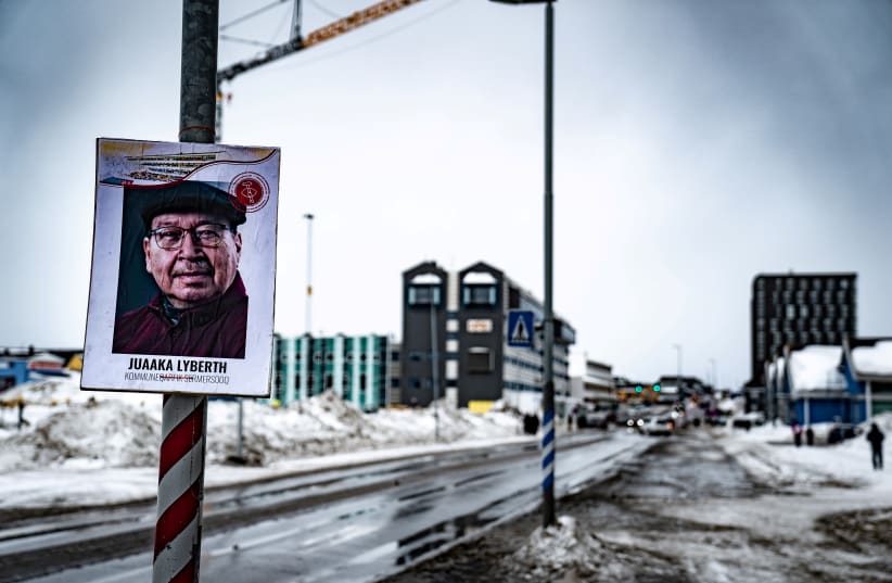 An electoral poster is displayed along a street ahead of the April 6 parliamentary election, in Nuuk, Greenland March 30, 2021. (photo credit: RITZAU SCANPIX/EMIL HELMS VIA REUTERS)