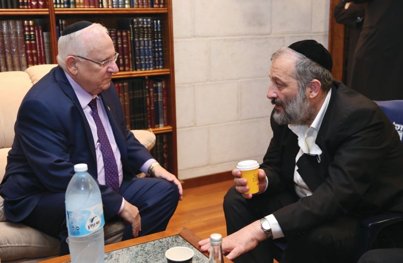 PRESIDENT REUVEN RIVLIN pays a shiva call to Minister Arye Deri upon the loss of his mother, Esther, in Jerusalem in 2017. (photo credit: YAAKOV COHEN/FLASH90)